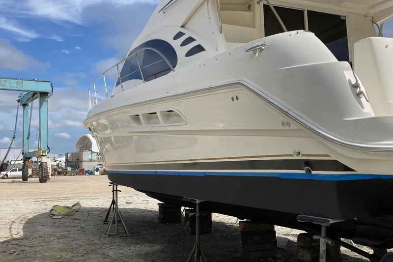 Slide: The Image of 2004 Sea Ray 420 Sedan Bridge yacht on dry dock, undergoing maintenance. - 58