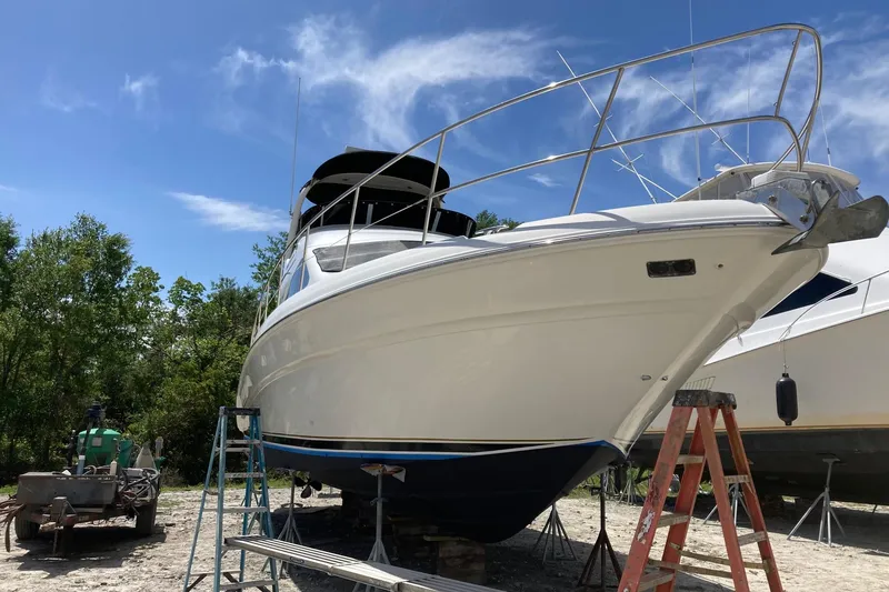 Slide: The Image of 2004 Sea Ray 420 Sedan Bridge yacht on dry dock under clear blue sky. - 59