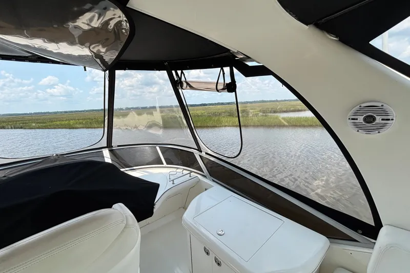 Slide: The Image of Interior view of 2004 Sea Ray 420 Sedan Bridge yacht with scenic waterway backdrop. - 63
