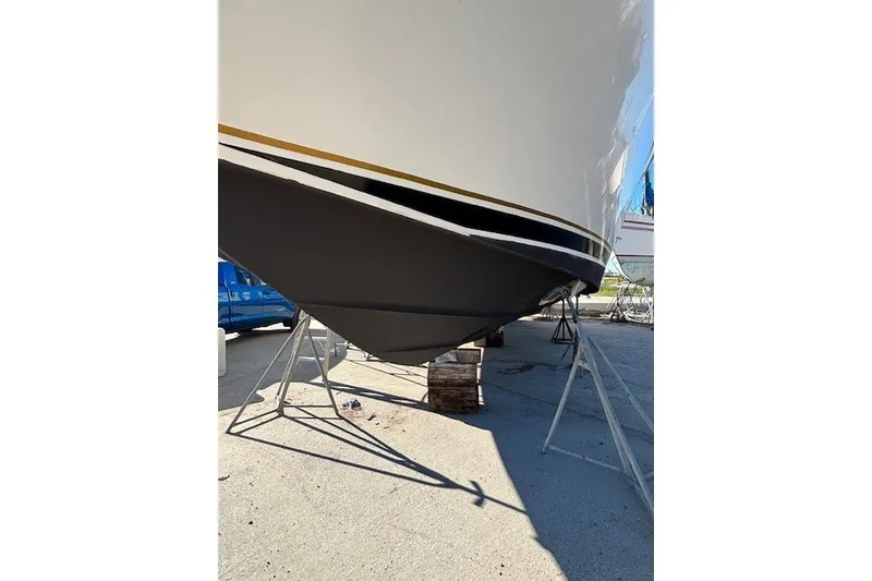 Slide: The Image of 2004 Sea Ray 420 Sedan Bridge boat hull on stands, outdoor setting. - 96