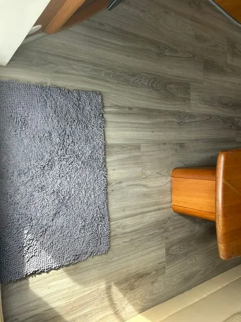Slide: The Image of Interior of a 2003 Silverton 42 Convertible with carpet and wooden furniture. - 29