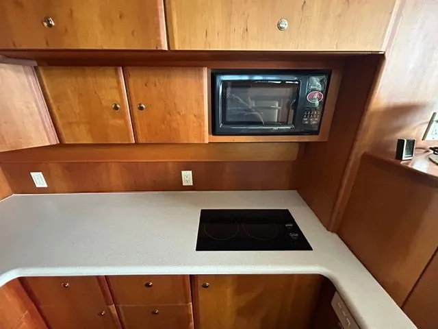 Slide: The Image of Kitchen area of the 2003 Silverton 42 Convertible yacht. - 35