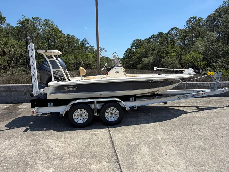 Slide: The Image of 2019 Scout 177 Sport boat on trailer parked outdoors. - 0
