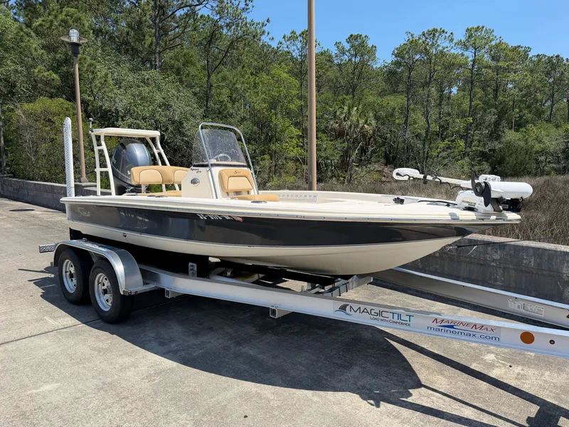 Slide: The Image of 2019 Scout 177 Sport boat on trailer parked outdoors. - 2