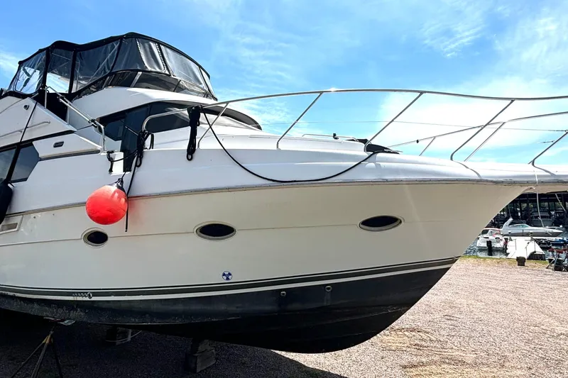 The Image of 1999 Silverton 453 Motor Yacht docked, featuring sleek design and spacious deck. - 1