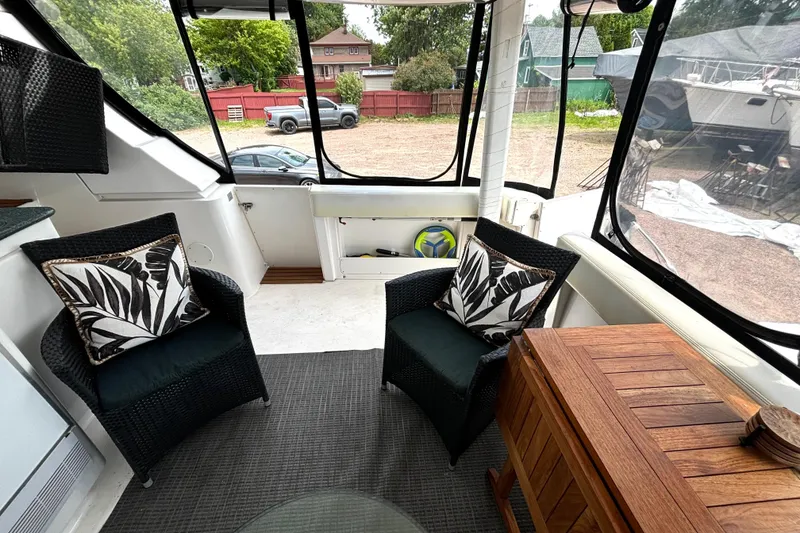 Slide: The Image of Interior of 1999 Silverton 453 Motor Yacht with wicker chairs and decorative pillows. - 11