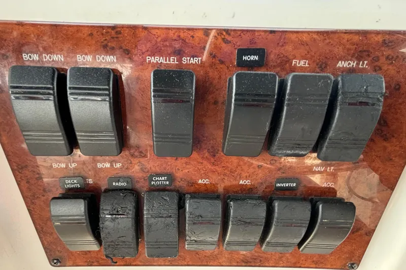 Slide: The Image of Control panel of a 1999 Silverton 453 Motor Yacht with labeled switches. - 25
