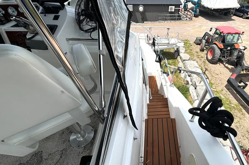 Slide: The Image of 1999 Silverton 453 Motor Yacht deck with wooden steps and marina view. - 30