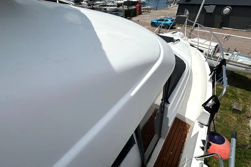 Slide: The Image of 1999 Silverton 453 Motor Yacht deck view at marina, showcasing sleek design and spacious layout. - 31