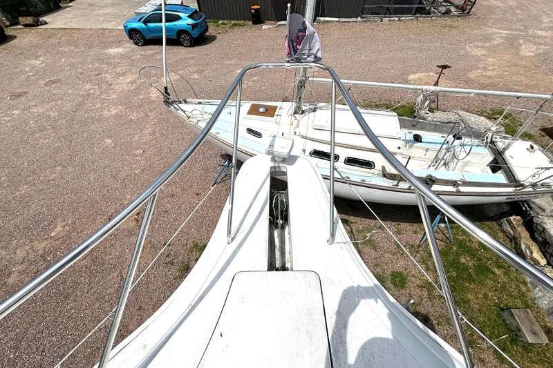 Slide: The Image of 1999 Silverton 453 Motor Yacht bow view, parked near a blue car and sailboat. - 33