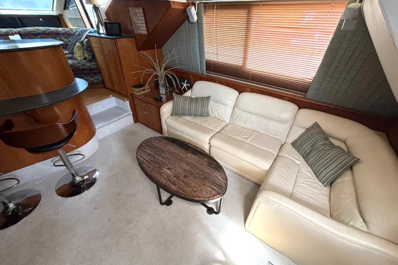 Slide: The Image of Luxurious interior of a 1999 Silverton 453 Motor Yacht with elegant seating and wooden accents. - 36