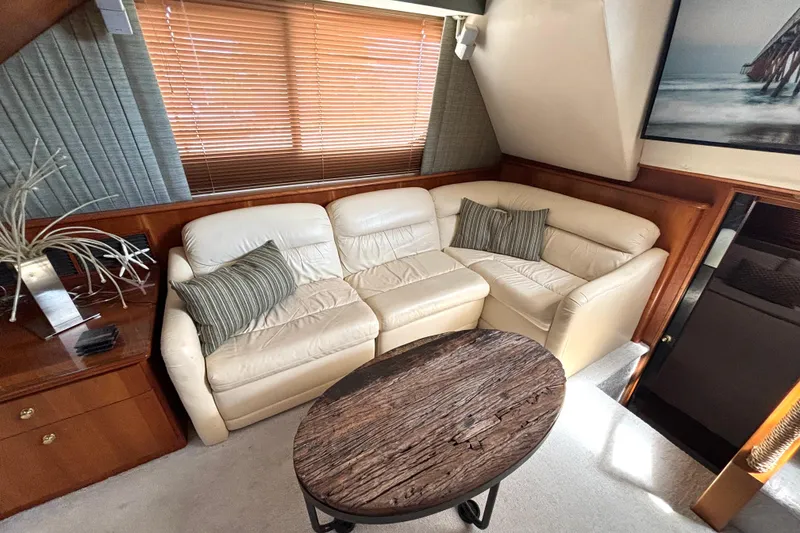 Slide: The Image of Luxurious interior of 1999 Silverton 453 Motor Yacht with leather seating and wooden table. - 37