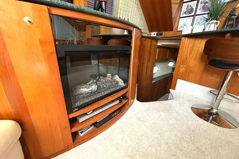 Slide: The Image of Interior of 1999 Silverton 453 Motor Yacht with wood paneling and modern fireplace. - 39