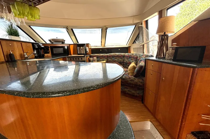 Slide: The Image of Luxurious interior of a 1999 Silverton 453 Motor Yacht with modern kitchen and cozy seating area. - 42