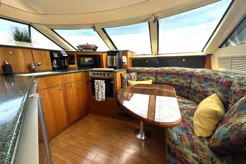 Slide: The Image of Interior of 1999 Silverton 453 Motor Yacht with cozy dining area and modern kitchen amenities. - 43