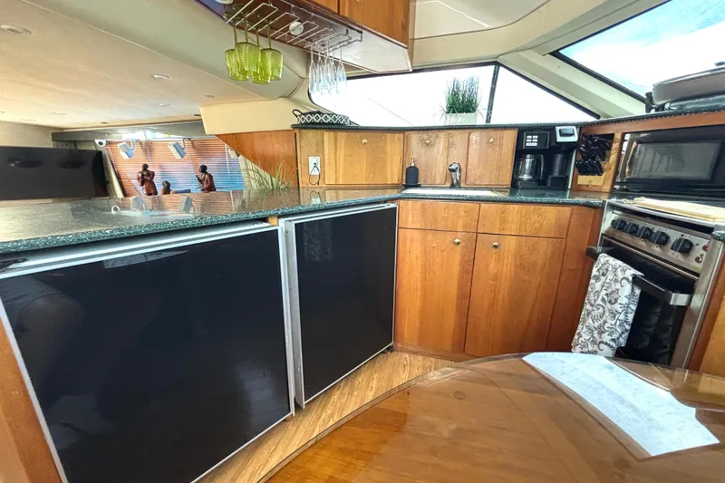Slide: The Image of Interior of 1999 Silverton 453 Motor Yacht kitchen with wood cabinets and modern appliances. - 44