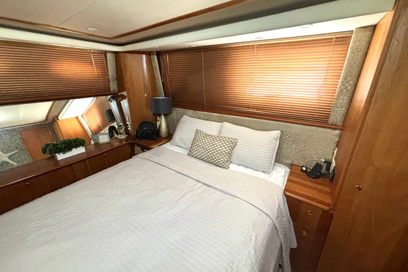 Slide: The Image of Luxurious bedroom interior of 1999 Silverton 453 Motor Yacht with elegant wood finishes. - 46