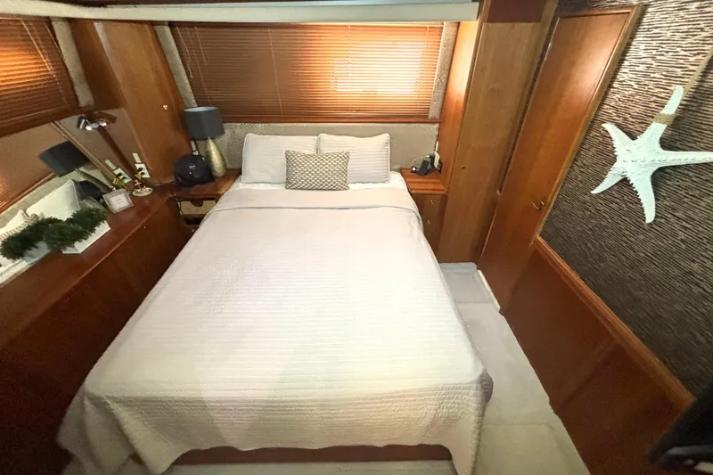 Slide: The Image of Luxurious bedroom interior of 1999 Silverton 453 Motor Yacht with elegant decor and cozy bedding. - 47