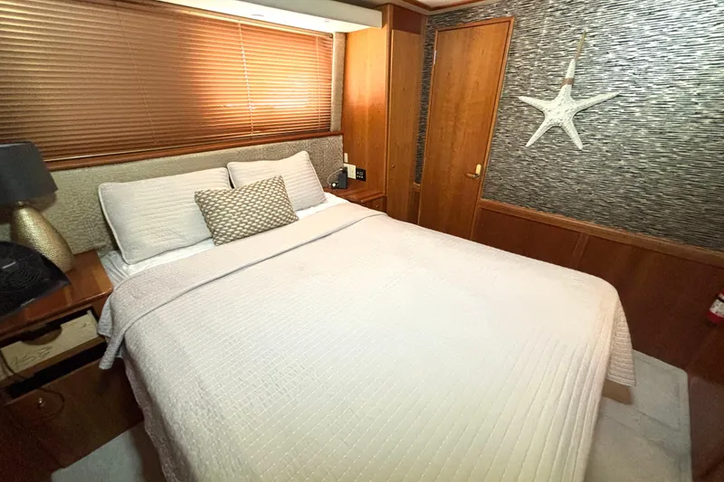 Slide: The Image of Cozy bedroom in 1999 Silverton 453 Motor Yacht with elegant decor and starfish wall art. - 48