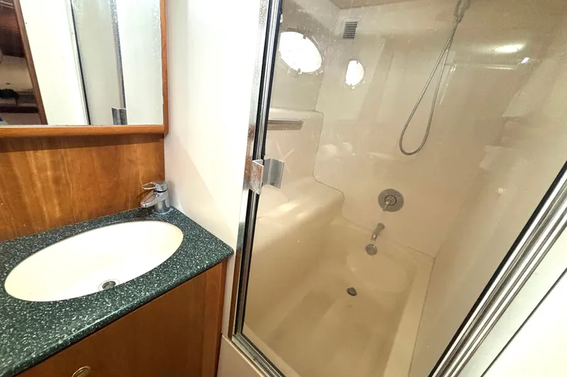 Slide: The Image of Bathroom interior of 1999 Silverton 453 Motor Yacht with shower and sink. - 51