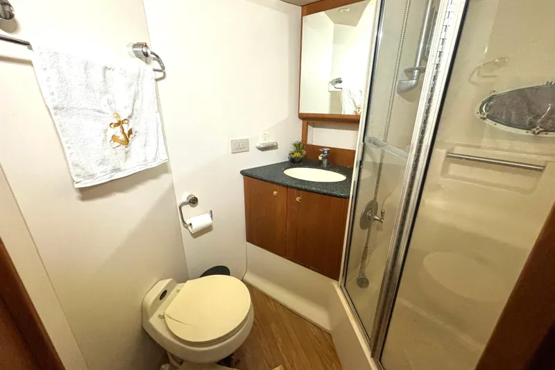 Slide: The Image of Bathroom interior of 1999 Silverton 453 Motor Yacht with shower and vanity. - 56