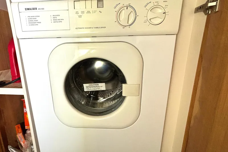 Slide: The Image of Washing machine inside 1999 Silverton 453 Motor Yacht laundry area. - 58
