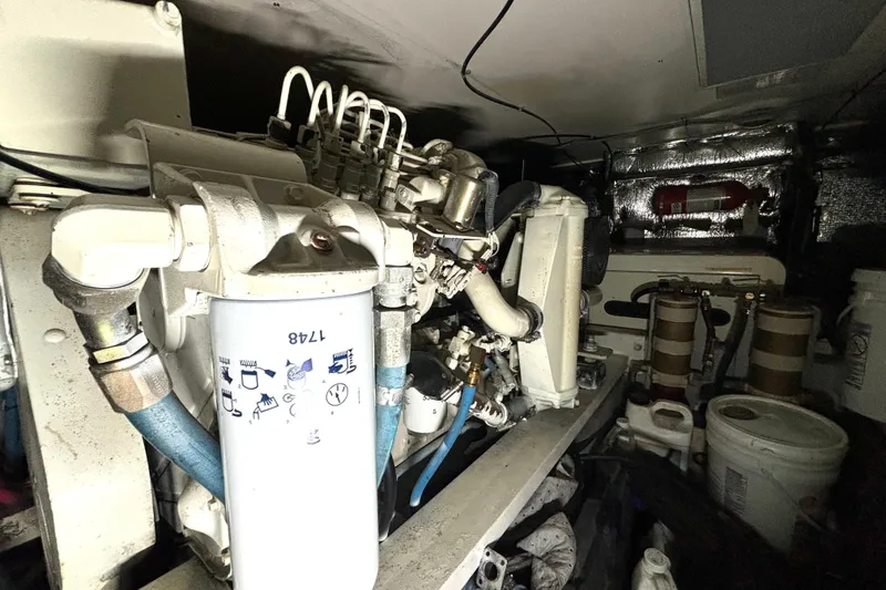 Slide: The Image of Engine room of a 1999 Silverton 453 Motor Yacht, showcasing mechanical components and filters. - 69