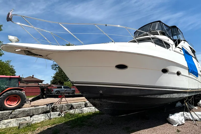 Slide: The Image of 1999 Silverton 453 Motor Yacht on dry dock, with blue sky background. - 7