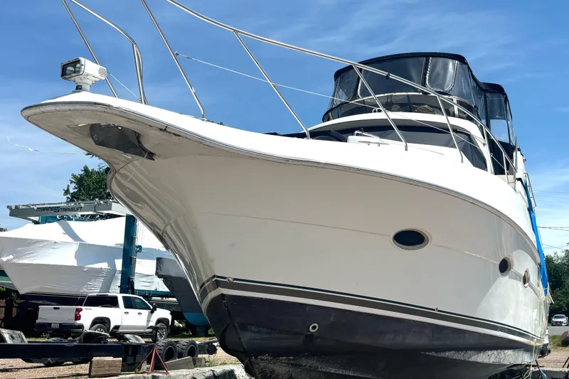 Slide: The Image of 1999 Silverton 453 Motor Yacht on dry dock, showcasing sleek design and sturdy build. - 8