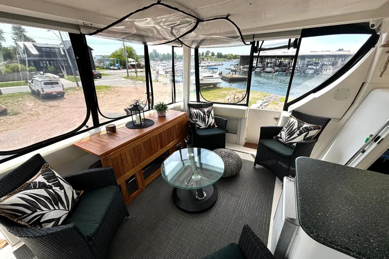 Slide: The Image of Interior of 1999 Silverton 453 Motor Yacht with elegant seating and marina view. - 9