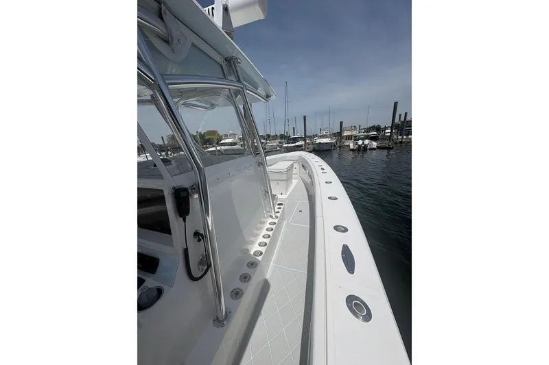 Slide: The Image of 2019 Concept 392 ProFish boat docked, showcasing sleek design and spacious deck. - 16