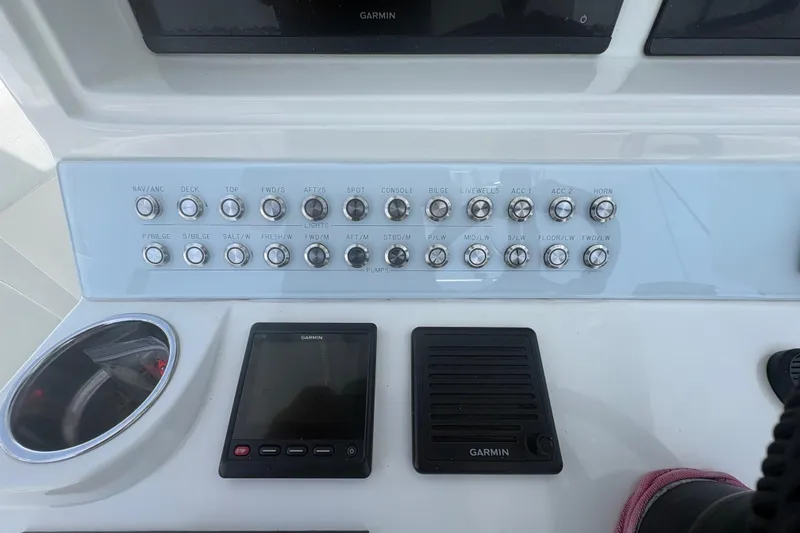 Slide: The Image of Control panel of a 2019 Concept 392 ProFish boat with various switches and Garmin display. - 17