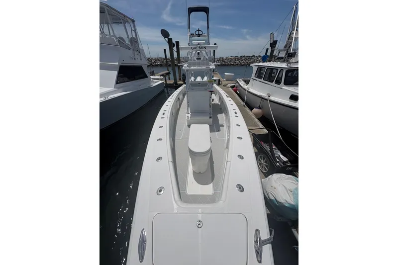 Slide: The Image of 2019 Concept 392 ProFish boat docked, showcasing sleek design and spacious deck. - 21