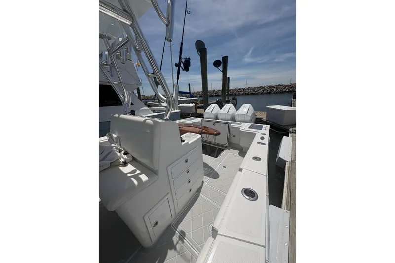 Slide: The Image of 2019 Concept 392 ProFish boat interior with seating and fishing equipment at dock. - 25