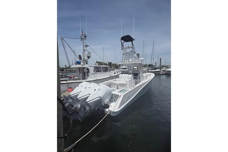 Slide: The Image of 2019 Concept 392 ProFish boat docked at marina with multiple outboard engines. - 3