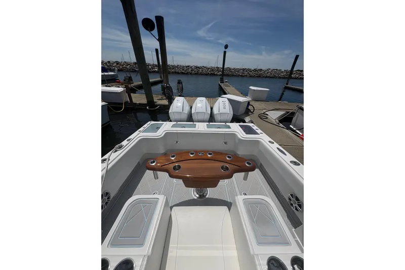 Slide: The Image of 2019 Concept 392 ProFish boat interior with fishing rod holders, docked at marina. - 38