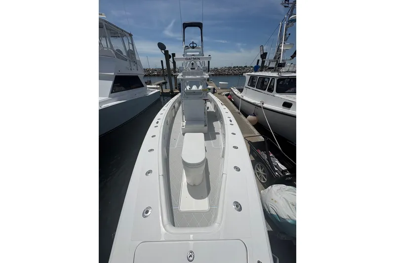 Slide: The Image of 2019 Concept 392 ProFish boat docked, showcasing sleek design and spacious deck. - 46