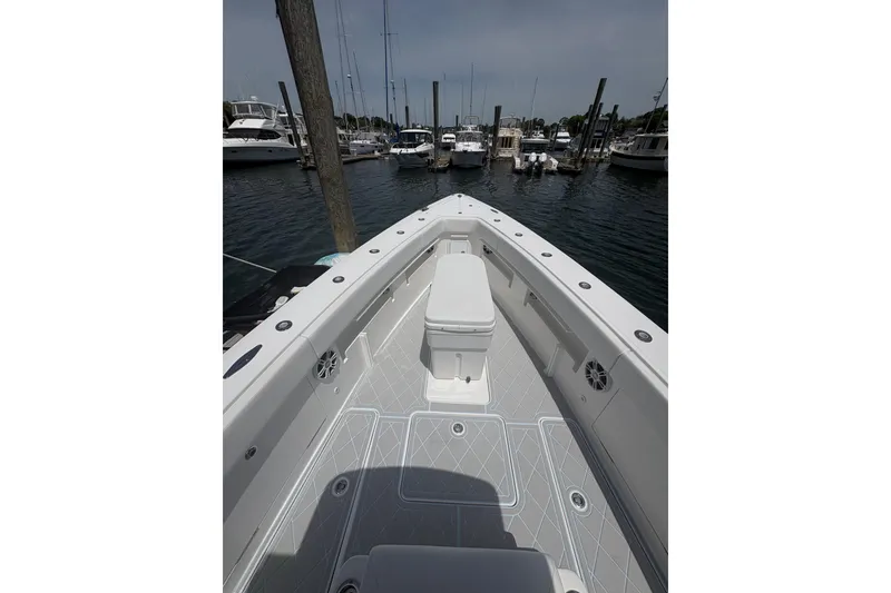 Slide: The Image of 2019 Concept 392 ProFish boat docked in a marina, showcasing spacious deck and seating. - 51