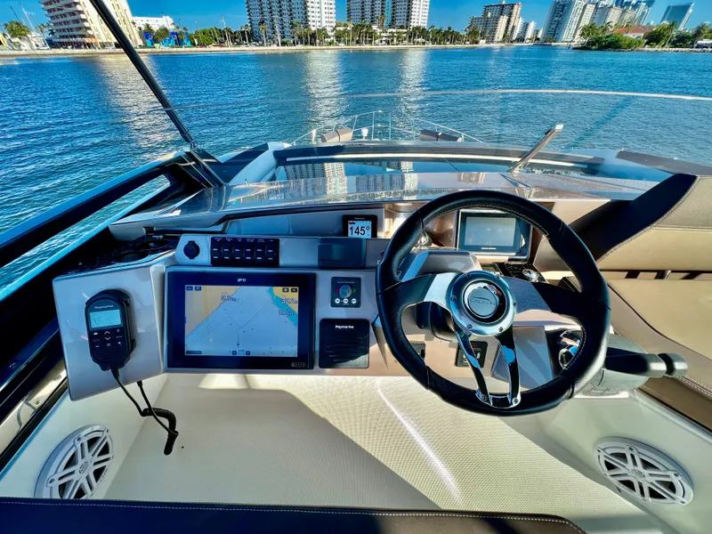 Slide: The Image of 2022 Galeon 470 Sky yacht helm with navigation system and waterfront view. - 11