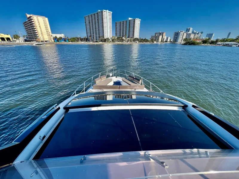 Slide: The Image of View from the bow of a 2022 Galeon 470 Sky yacht in a coastal city. - 12