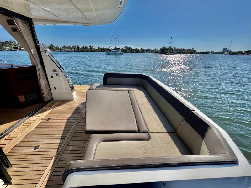 Slide: The Image of Galeon 470 Sky 2022 yacht with spacious deck seating overlooking serene waters. - 16