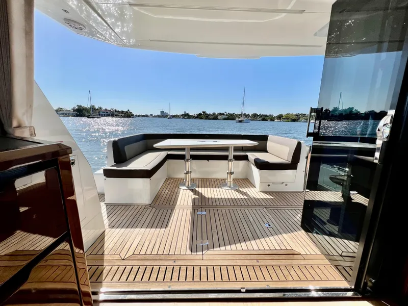 Slide: The Image of 2022 Galeon 470 Sky yacht with spacious outdoor seating area and scenic water view. - 19