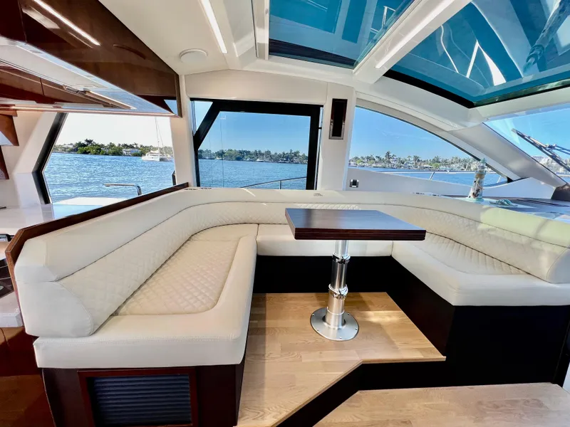 Slide: The Image of Interior of 2022 Galeon 470 Sky yacht with luxurious seating and waterfront view. - 24