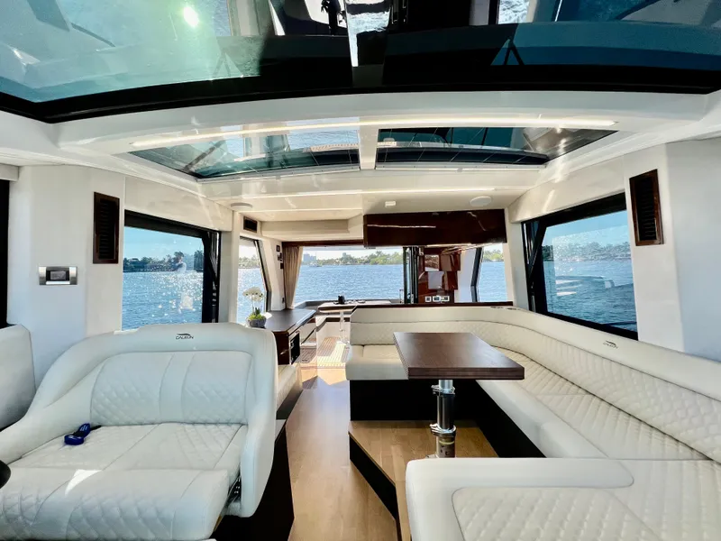 Slide: The Image of Luxurious interior of the 2022 Galeon 470 Sky yacht with panoramic windows and plush seating. - 25