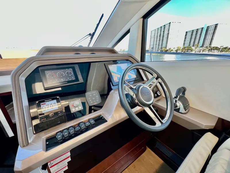 Slide: The Image of Helm station of 2022 Galeon 470 Sky yacht with modern controls and steering wheel. - 26