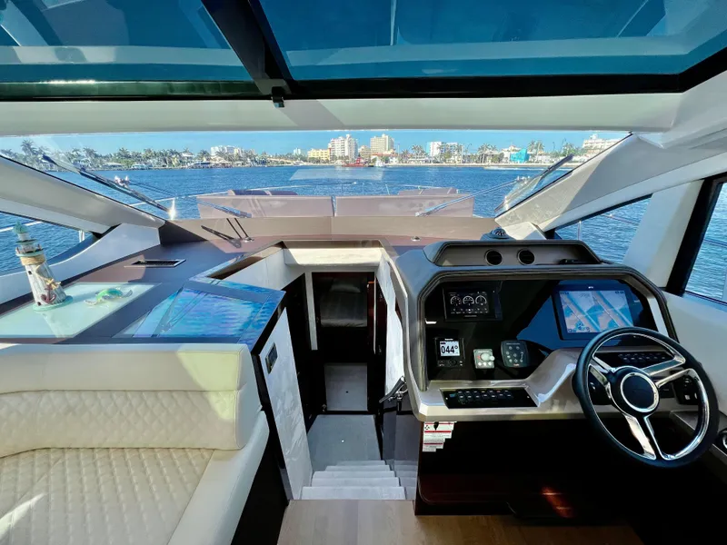 Slide: The Image of Interior helm of 2022 Galeon 470 Sky yacht with waterfront view. - 27