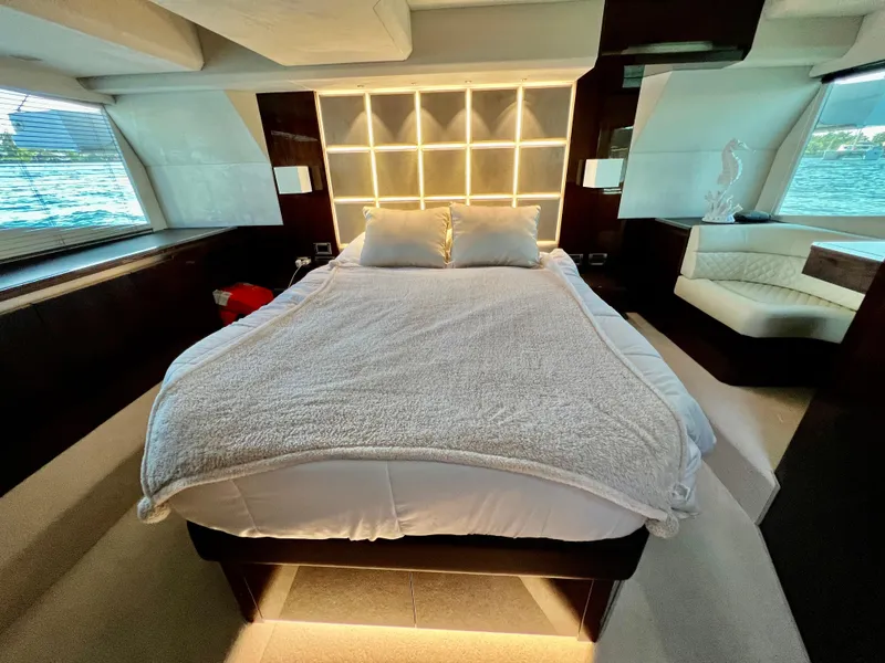 Slide: The Image of Luxurious bedroom on the 2022 Galeon 470 Sky yacht with modern lighting and large windows. - 32