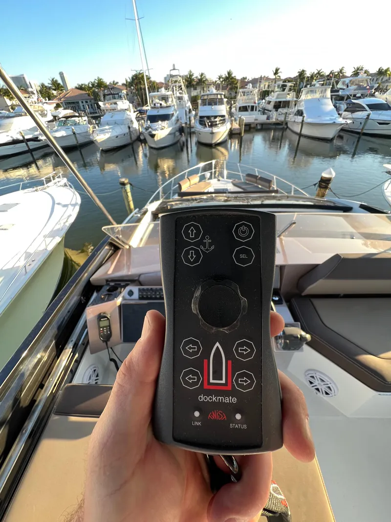 Slide: The Image of Hand holding Dockmate remote on 2022 Galeon 470 Sky yacht at marina. - 39