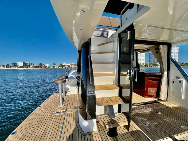 Slide: The Image of 2022 Galeon 470 Sky yacht deck with stairs and waterfront view. - 7
