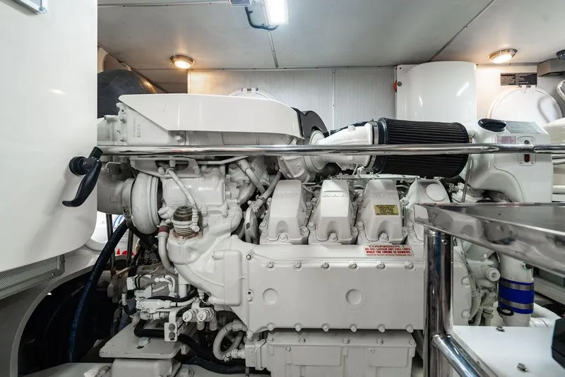 Slide: The Image of Engine room of a 2013 Custom 73 Lanzarote yacht, featuring a clean, white engine. - 115